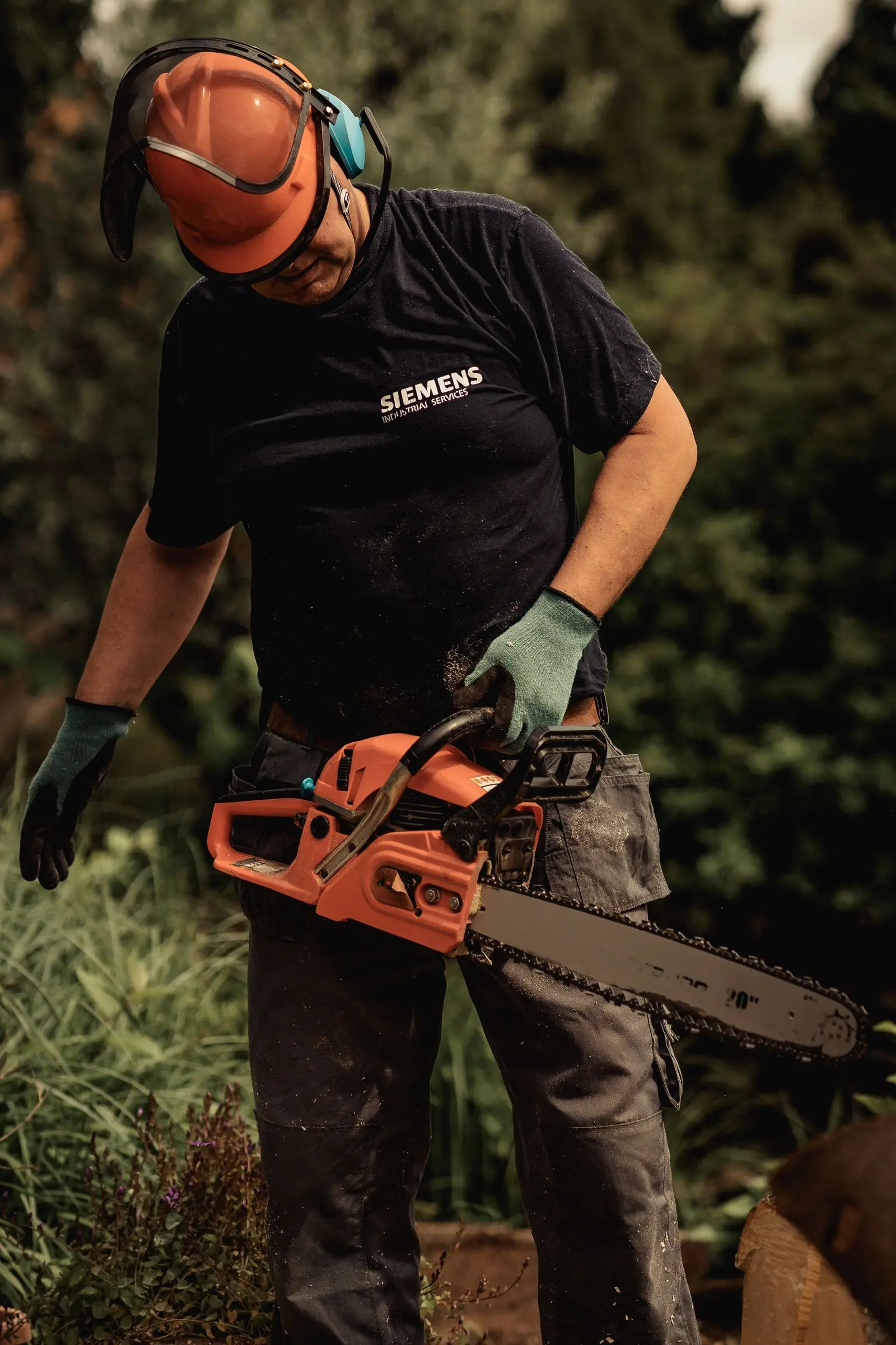Gloved hand holding a chainsaw